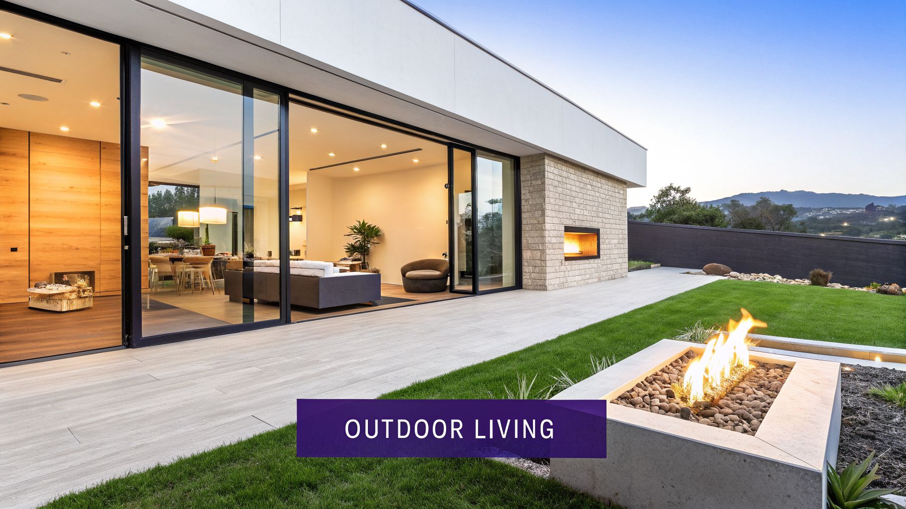 A modern home exterior with a large patio, lush green lawn, a cozy fire pit, and an outdoor fireplace.