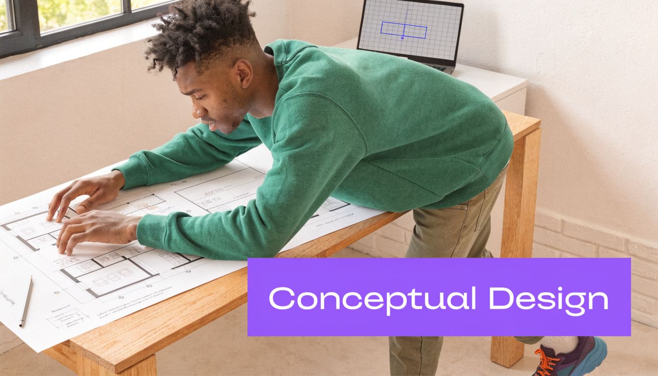 An architect in a green sweater reviewing detailed architectural floor plan drawings at a wooden desk.