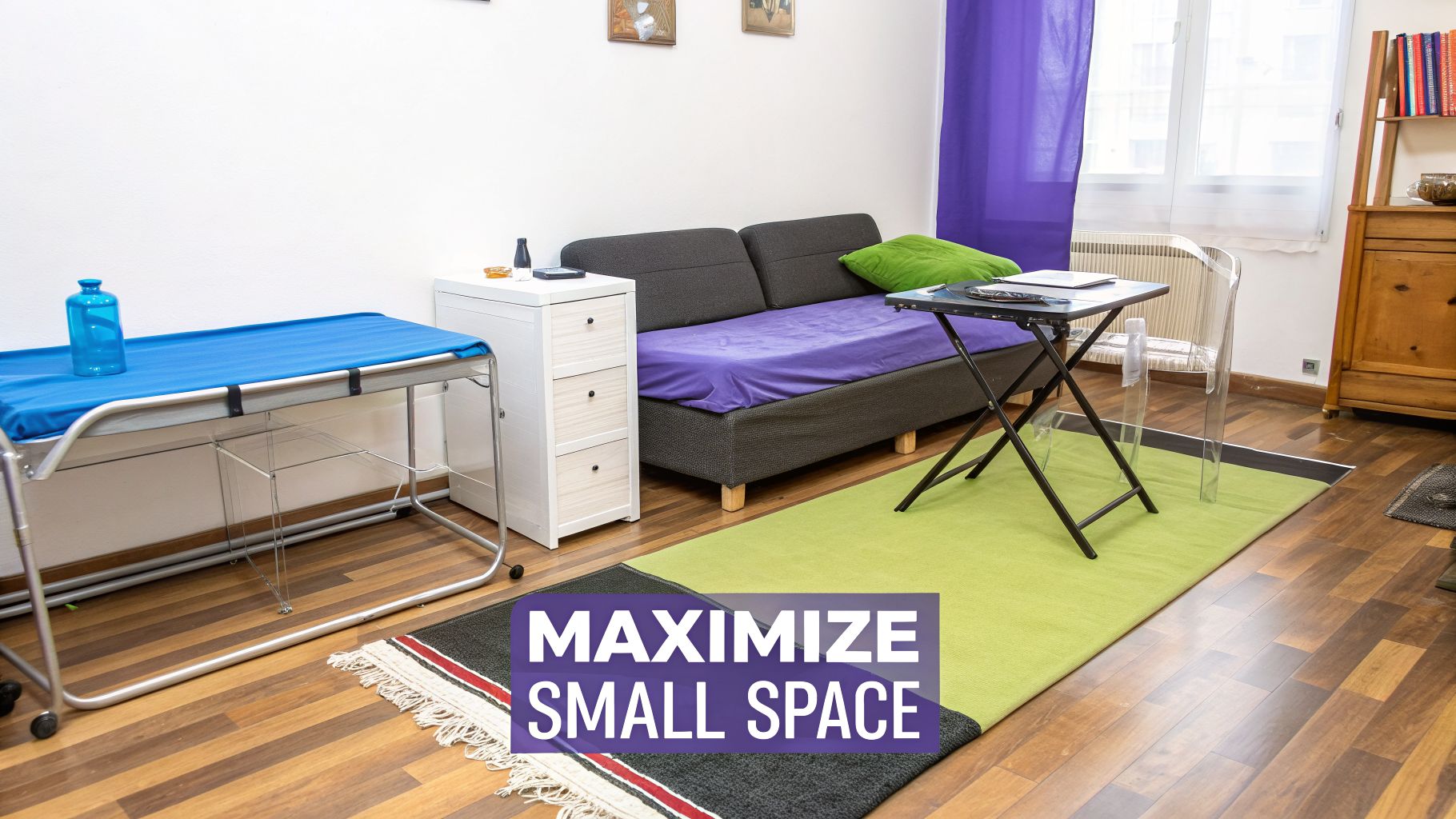 A small room with various furniture arranged to maximize space, including a bed, sofa, dresser, and table.