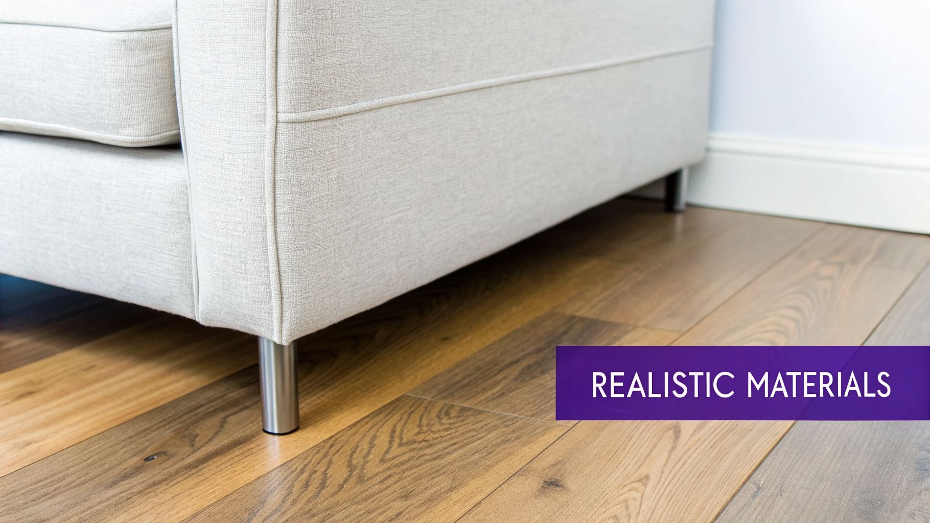 A modern light gray fabric sofa with shiny metal legs sits on a textured wooden floor.